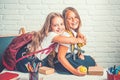 Little girls eat apple at lunch break. little girls eambrace at school lesson. Royalty Free Stock Photo