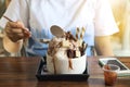 Little girls are eating Bingsu Vanilla ice cream with brownie, chocolate chip and chocolate sauce Royalty Free Stock Photo