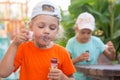 Little girls enthusiastically inflated bubbles in street