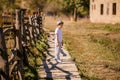 Little boy im the hat on the old farm. Autumn time