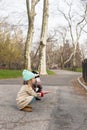 Little girls feeds a squirrel in Central park, New