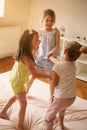 Little girls having fun together in bed. Little girls playing at Royalty Free Stock Photo