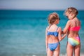 Two little happy girls have a lot of fun at tropical beach playing together Royalty Free Stock Photo