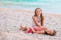 Two little happy girls have a lot of fun at tropical beach playing together Royalty Free Stock Photo