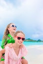 Little girls having fun at tropical beach playing together at shallow water. Adorable little sisters at beach during Royalty Free Stock Photo