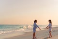 Little girls having fun at tropical beach playing together at shallow water. Royalty Free Stock Photo