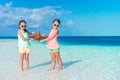 Two little happy girls have a lot of fun at tropical beach playing together Royalty Free Stock Photo