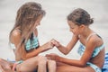 Little girls having fun at tropical beach playing together Royalty Free Stock Photo