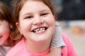 Little girls hugging in front of chalkboard Royalty Free Stock Photo