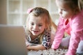 Little girls with laptop at home. Royalty Free Stock Photo