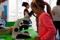 Little Girls learning science at the microscope