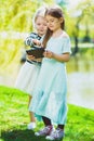 Little girls listening to music on headphones in a spring park outdoor Royalty Free Stock Photo
