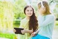 Little girls listening to music on headphones in a spring park outdoor Royalty Free Stock Photo