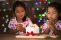 Little girls make folded hand to wish the good things for their birthday Royalty Free Stock Photo