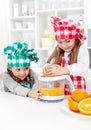 Little girls making fresh orange juice Royalty Free Stock Photo