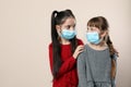 Little girls in medical masks on background, space for text. Virus protection