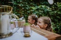 Little girls at outdoor wedding garden party. Royalty Free Stock Photo