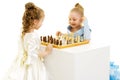 Little girls play chess.