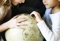 Little girls playing with a globe Royalty Free Stock Photo