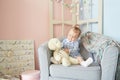 A little girls playing in the house for dolls with bear Royalty Free Stock Photo