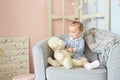 A little girls playing in the house for dolls with bear Royalty Free Stock Photo