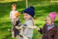 Little girls playing with husky puppy in the park Royalty Free Stock Photo