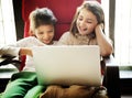 Little girls playing with a laptop Royalty Free Stock Photo