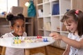 Little girls playing ludo board game Royalty Free Stock Photo