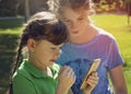 Little girls playing with phone