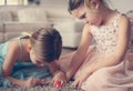 Little girls polish nails to etch other.