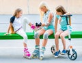 Little girls putting on rollerskates