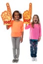 Little girls raises arms with foam finger