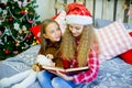 Little girls read book, Christmas time Royalty Free Stock Photo