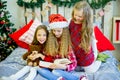 Little girls read book, Christmas time Royalty Free Stock Photo