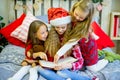 Little girls read book, Christmas time Royalty Free Stock Photo