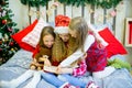 Little girls read book, Christmas time Royalty Free Stock Photo