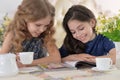 Little girls reading a magazine Royalty Free Stock Photo