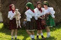 Little girls Romanian costume Maramures with lamb