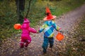 Little girls run to trick or treat, halloween celebration