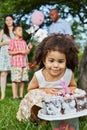 Little girls sits squatted and look at birthday