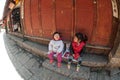 Little girls sitting and happiness in Lijiang Dayan Old town. Royalty Free Stock Photo