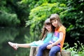 Little girls sitting on stump Royalty Free Stock Photo
