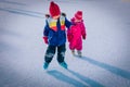 Little girls skating together in snow, kids winter activities Royalty Free Stock Photo
