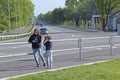 Little girls take pictures of each other near the highway. Happy children Royalty Free Stock Photo