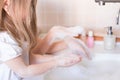 Little girls wash their hands in the sink with soap in the foam. Protection against coronovirus covid-2019 using personal hygiene Royalty Free Stock Photo