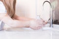 Little girls wash their hands in the sink with soap in the foam. Protection against coronovirus covid-2019 using personal hygiene Royalty Free Stock Photo