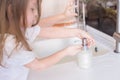 Little girls wash their hands in the sink with soap in the foam. Protection against coronovirus covid-2019 using personal hygiene Royalty Free Stock Photo