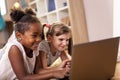 Little girls watching cartoons on laptop computer