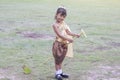 Little girls wearing traditional costume thai style play Banana rib hobbyhorse riding. Royalty Free Stock Photo