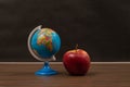 Little globe and a red apple